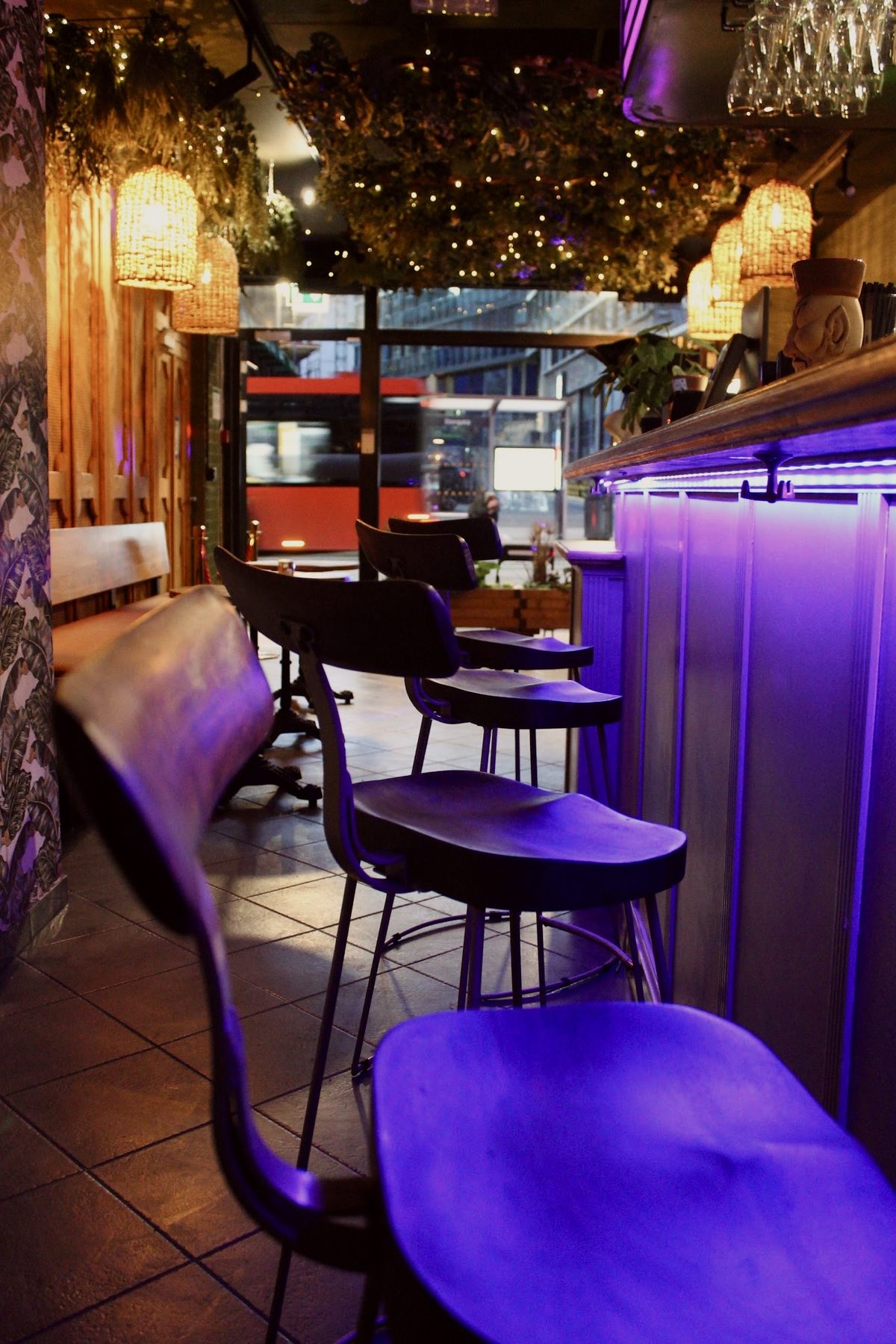 Bar stools along the lit counter at Labyrinth Bar