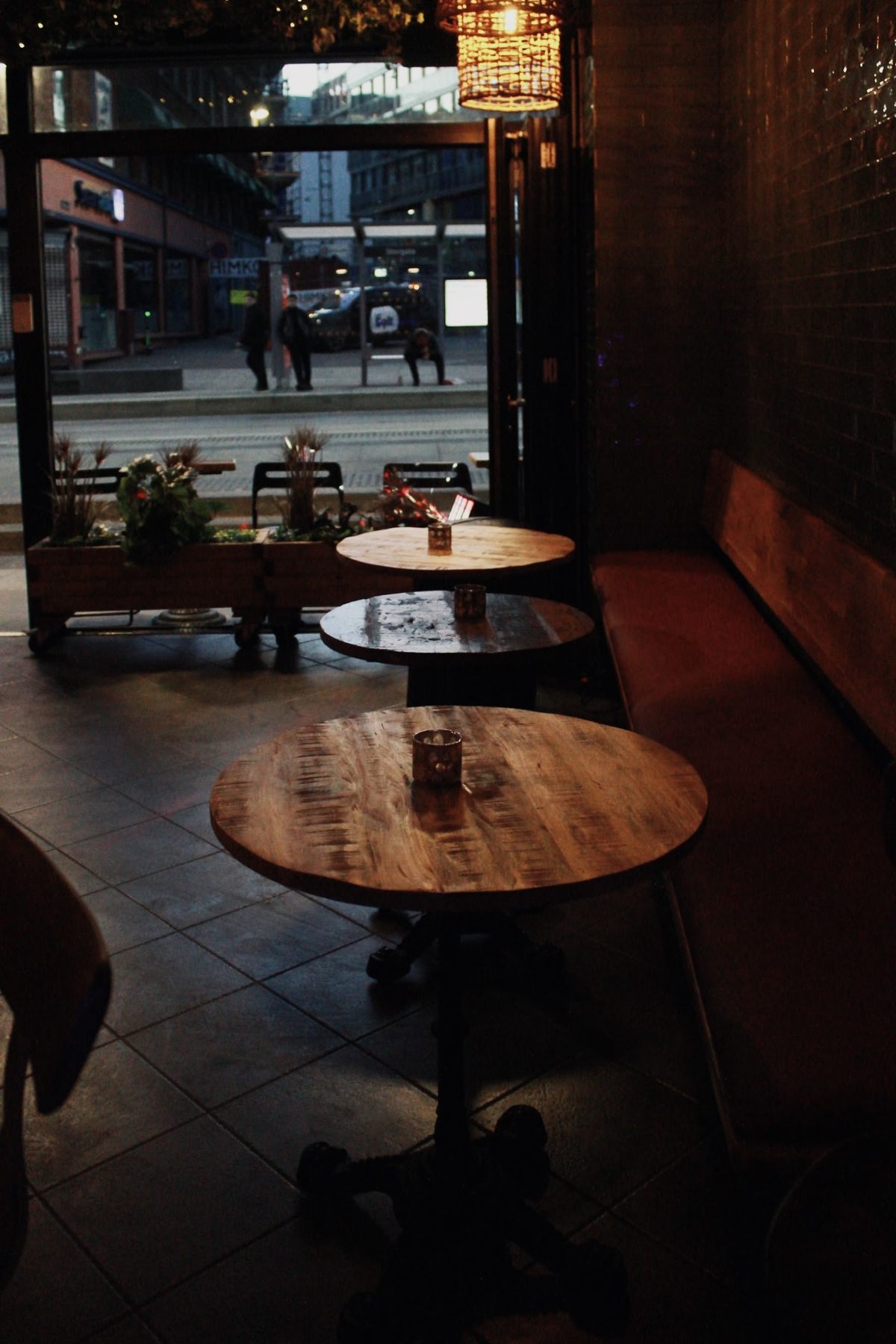 Wooden tables by the window looking onto Storgata